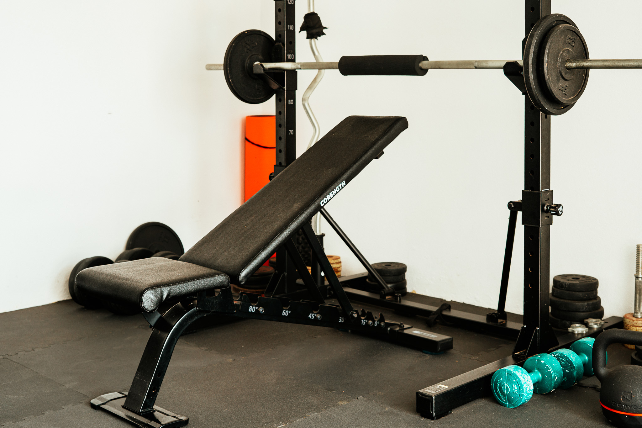 Adjustable bench in front of the barbell rack