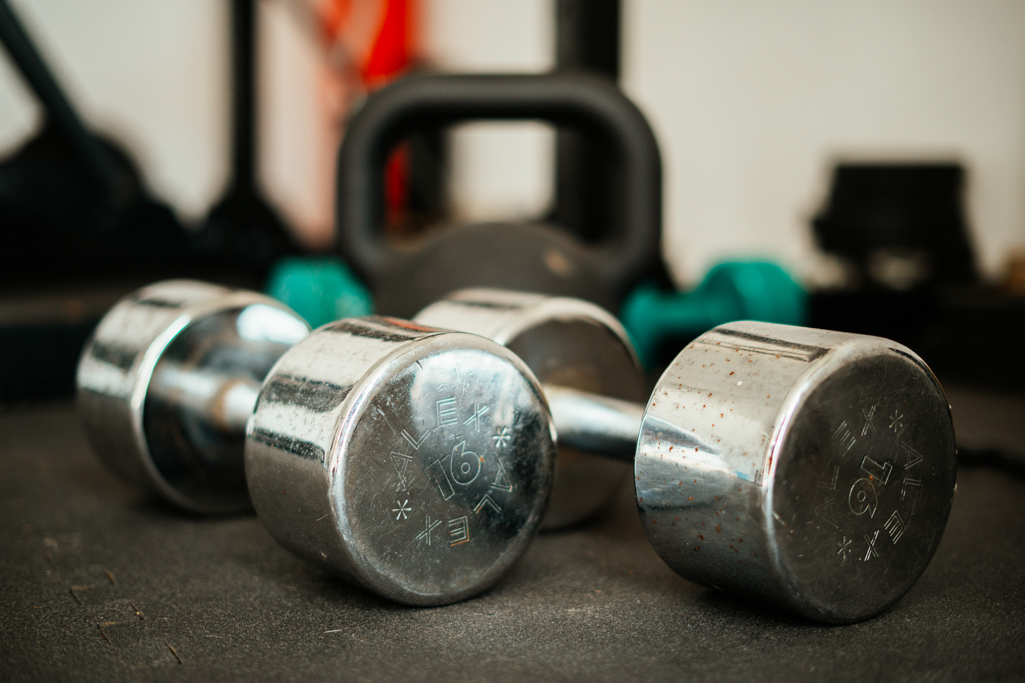 Chrome dumbbells with a kettlebell behind