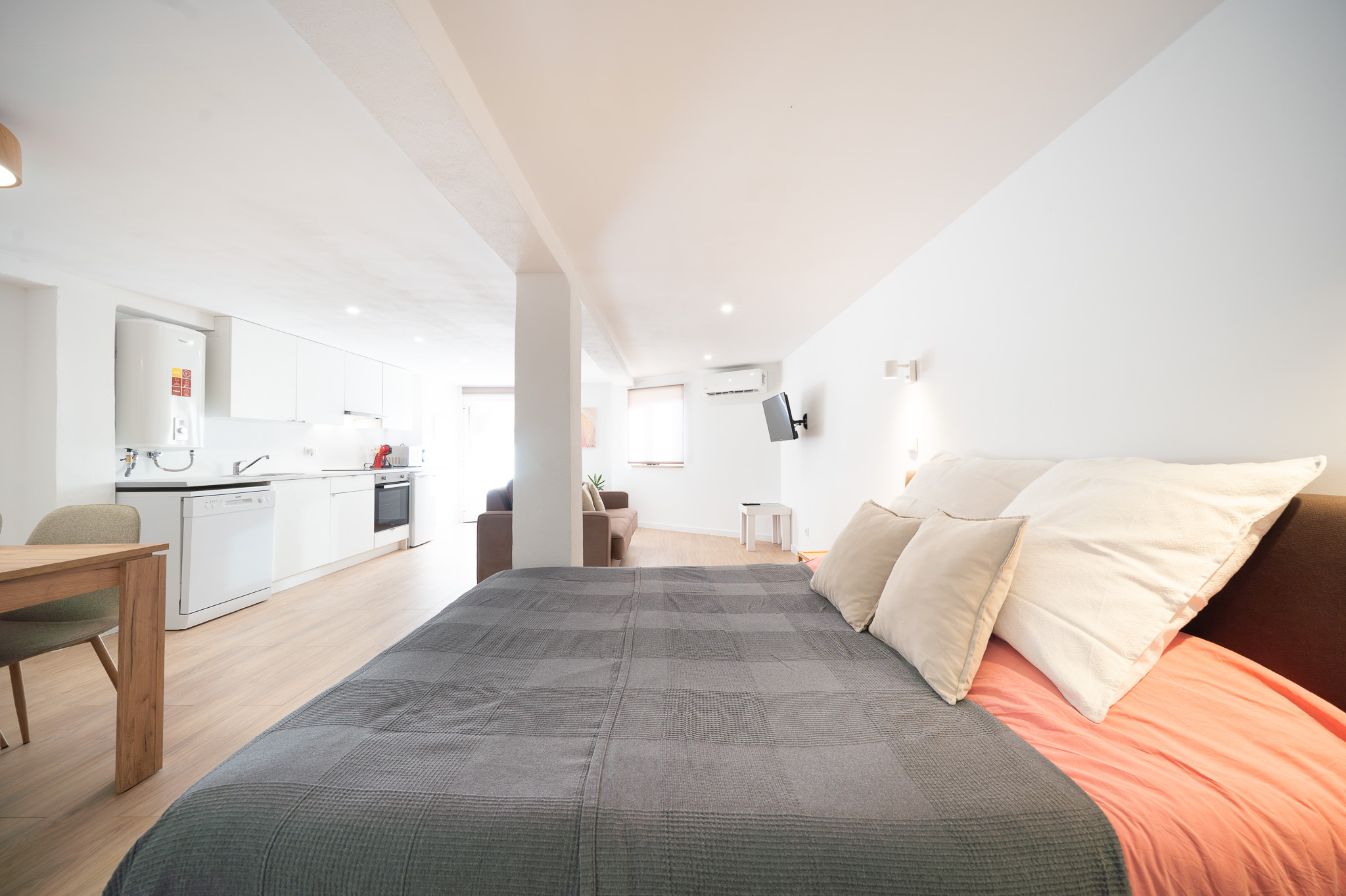 Studio double bed looking toward the kitchen and sofa