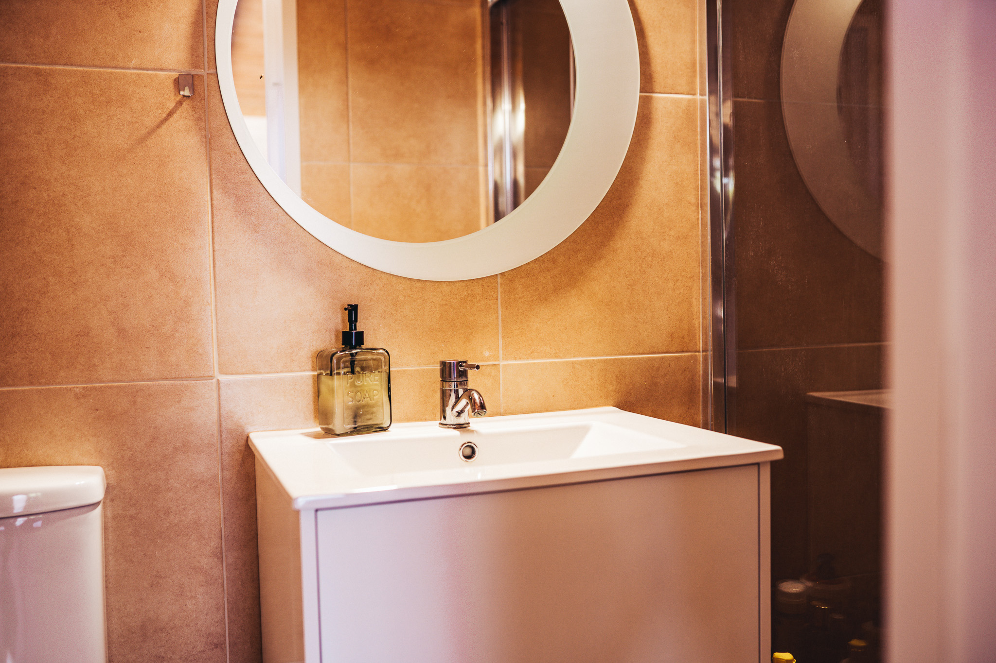 Cabin bathroom sink with round mirror