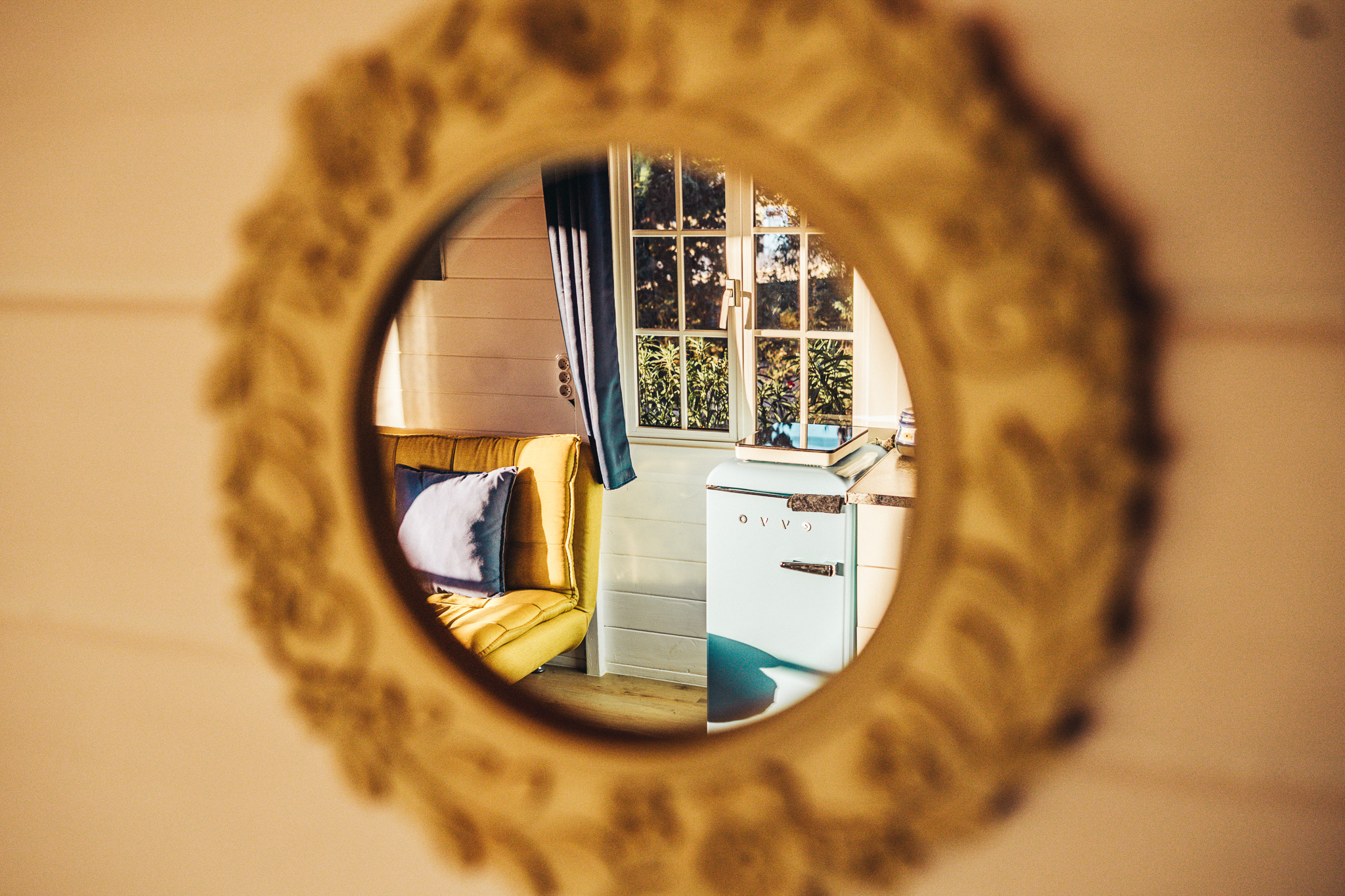 Round mirror reflecting the cabin living area