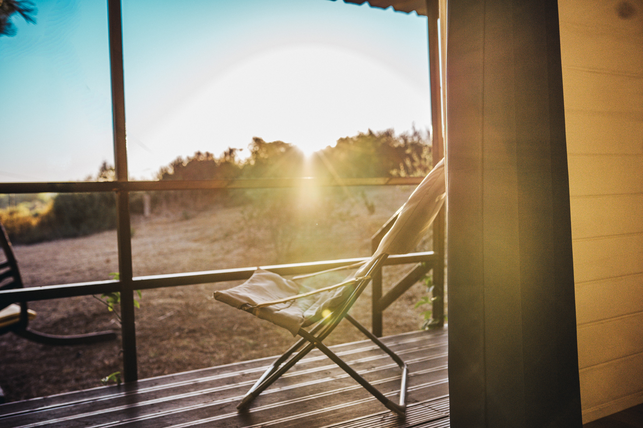 Lounge chair on the cabin terrace at sunset
