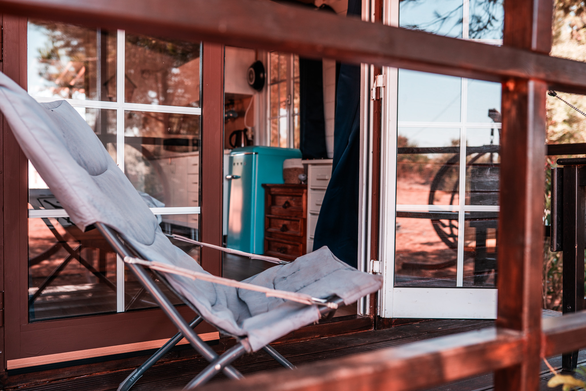 Lounge chair on the terrace by the open cabin door
